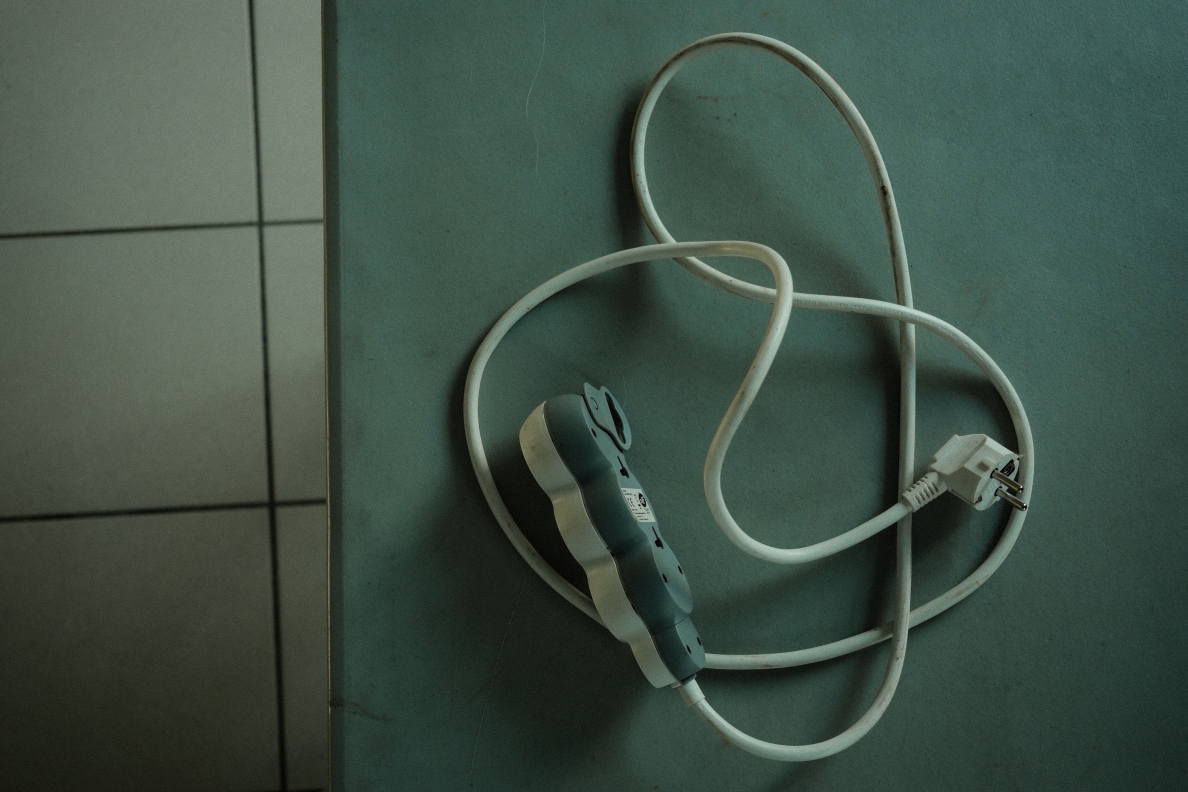 An extension cord on the floor during a community workshop